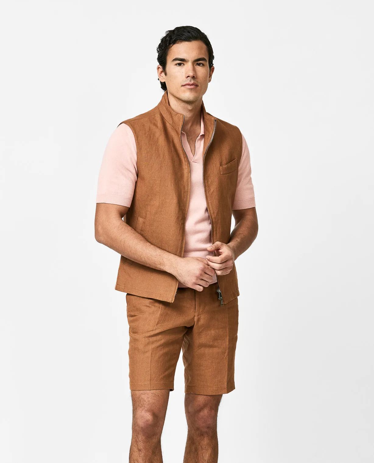 Peach polo, cognac linen vest, & matching bermudas