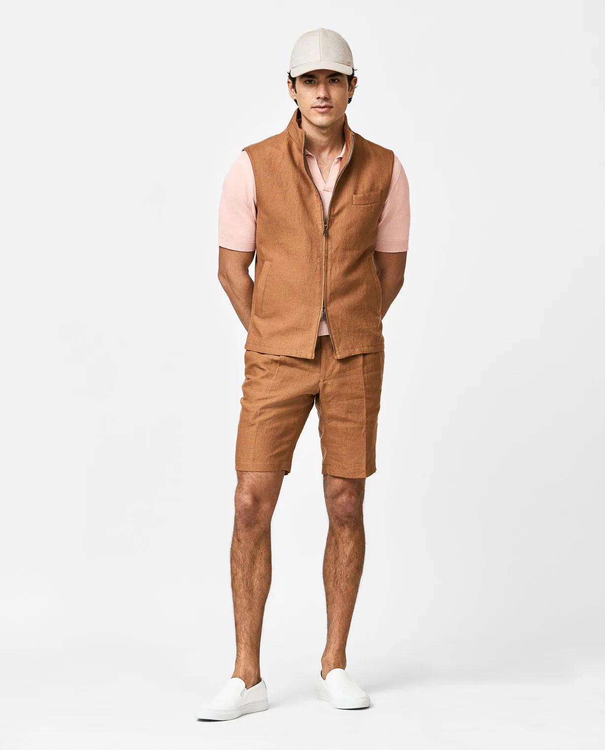 Peach polo, cognac linen vest, & matching bermudas